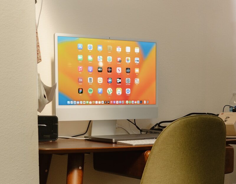 Photo by Fujiphilm A modern computer setup with a desk and chair.
